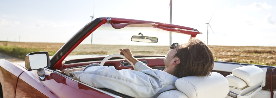 Man enjoying the open road driving a convertible with the top down